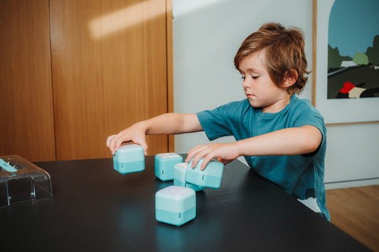 Young boy playing with the PlayCubes.